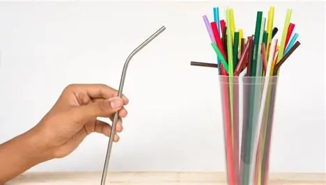 Person politely refusing a plastic straw at a café to reduce plastic waste.