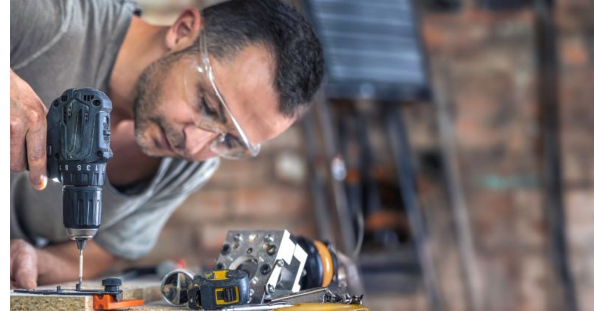Person repairing small appliance with tools at kitchen table, DIY repair culture, fixing instead of replacing"