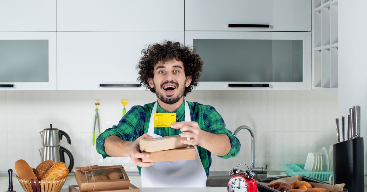 "Happy man unboxing zero waste online order with sustainable kitchen products, starting eco-friendly journey