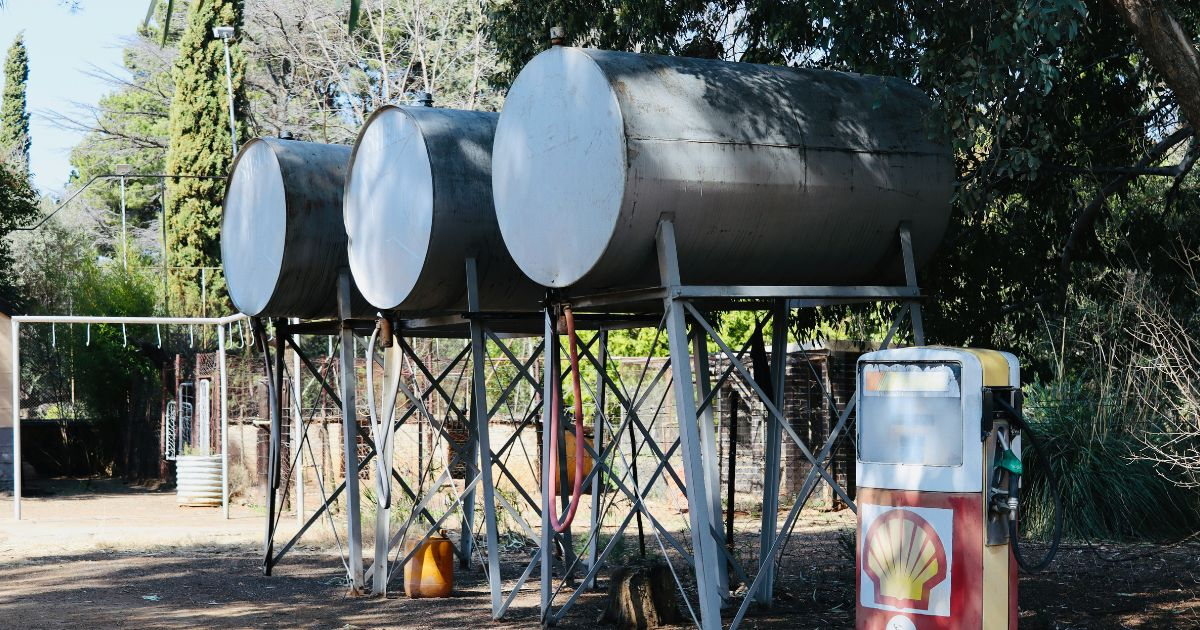 Complete rainwater harvesting system with barrels, downspout connection, and drip irrigation