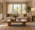 Neutral living room with a linen sofa, wood coffee table, upholstered chair and built-in storage.